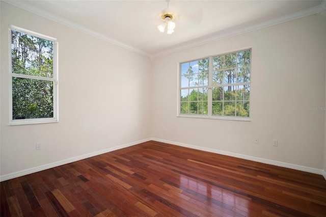 unfurnished room with baseboards, crown molding, and hardwood / wood-style floors