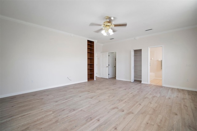 unfurnished bedroom with light wood-type flooring, ceiling fan, baseboards, ensuite bath, and ornamental molding
