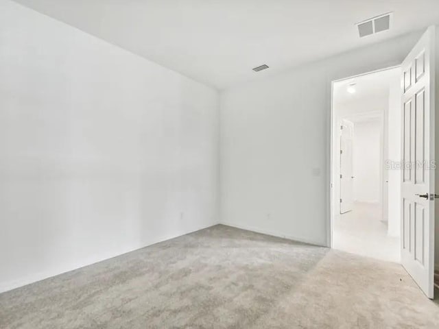 carpeted spare room with visible vents