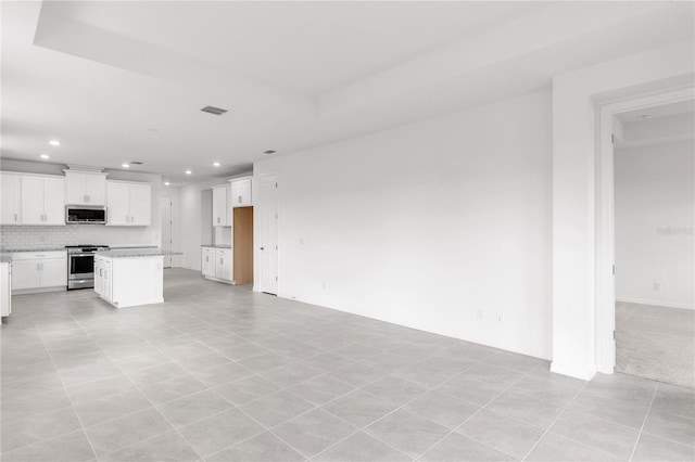 unfurnished living room with recessed lighting, visible vents, and light tile patterned floors
