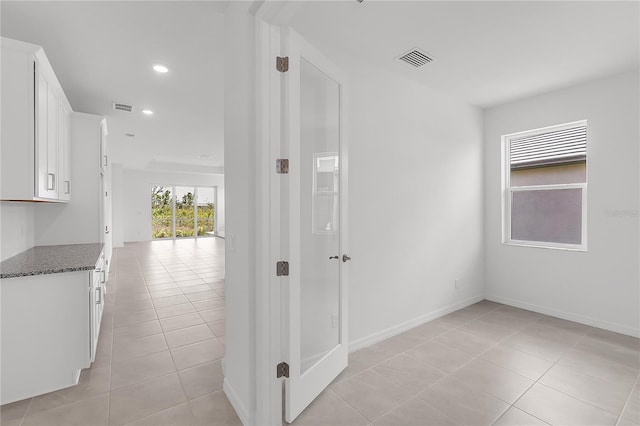 hallway featuring recessed lighting, visible vents, and light tile patterned floors