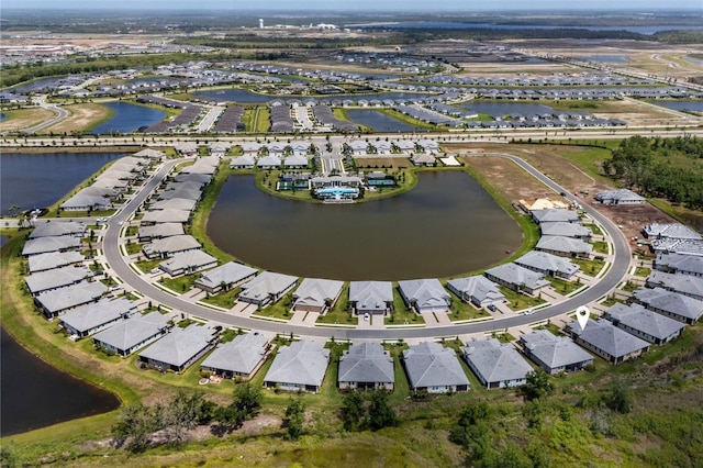 birds eye view of property with a residential view and a water view