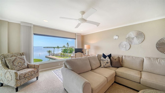 living room with ornamental molding, carpet floors, ceiling fan, and baseboards