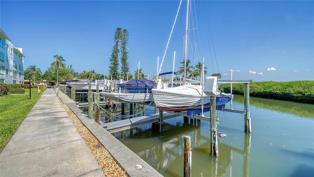 dock area with boat lift and a water view
