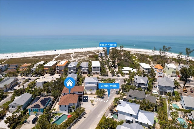 aerial view featuring a beach view, a residential view, and a water view