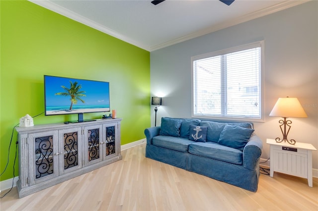 living area with baseboards, wood finished floors, and crown molding