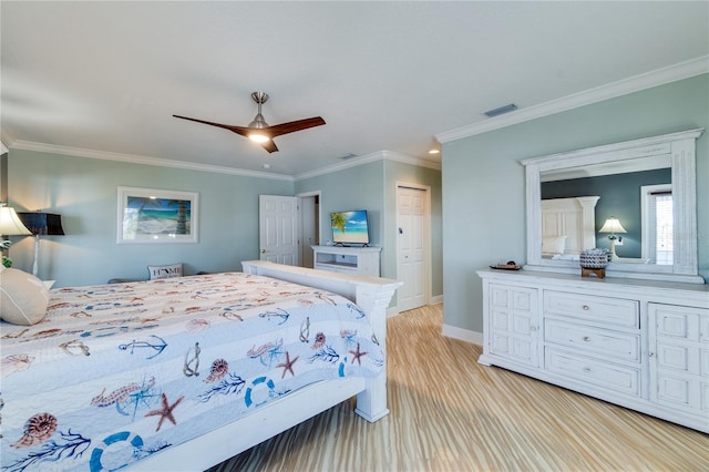 bedroom featuring a ceiling fan, crown molding, a closet, baseboards, and visible vents