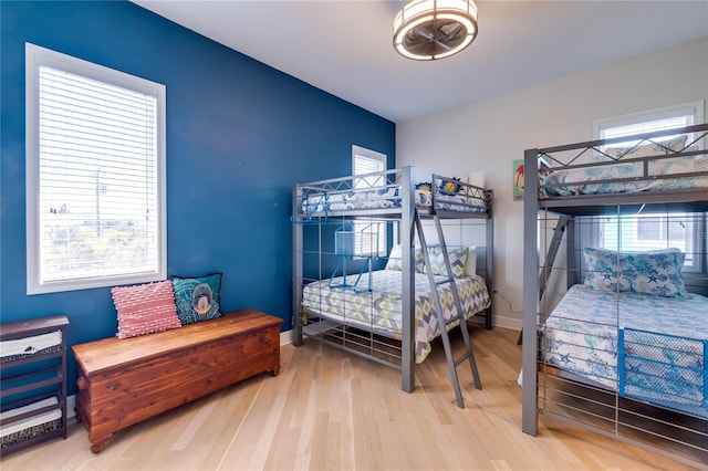 bedroom with baseboards and wood finished floors