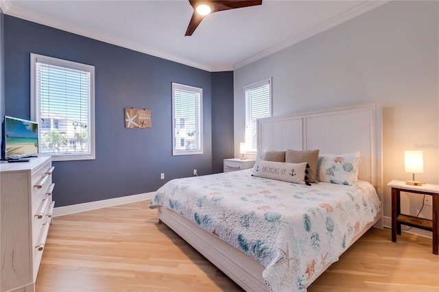 bedroom featuring light wood-type flooring, a ceiling fan, baseboards, and crown molding