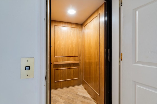 interior details with wood finished floors and elevator