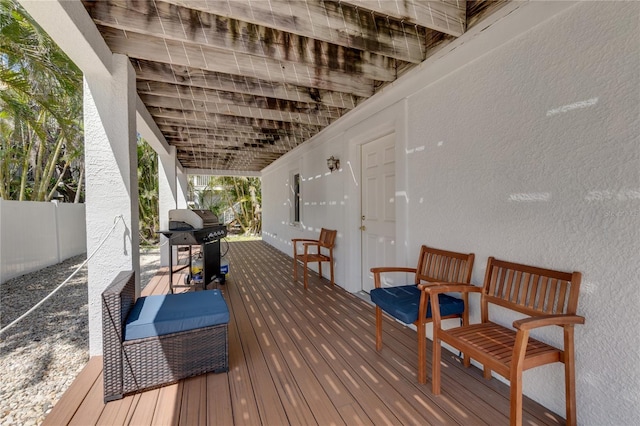 wooden terrace with grilling area and fence