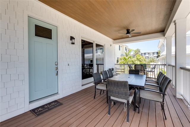 deck featuring outdoor dining space and a ceiling fan