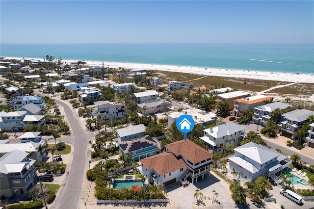 bird's eye view with a residential view, a view of the beach, and a water view