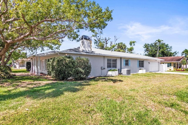 2961 Valencia Rd, Venice, FL 34293 - view of front of home featuring an attached garage, central AC, a front lawn, and stucco siding