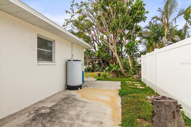 2961 Valencia Rd, Venice, FL 34293 - view of yard featuring a patio area, gas water heater, and fence