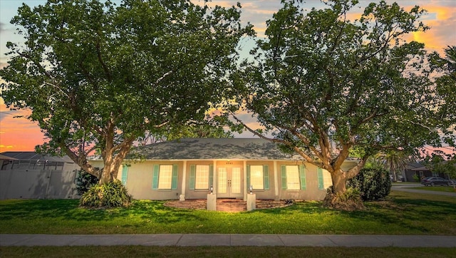 2961 Valencia Rd, Venice, FL 34293 - single story home with fence, french doors, a front yard, and stucco siding
