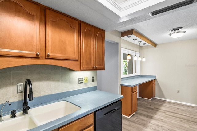 2961 Valencia Rd, Venice, FL 34293 - kitchen with a sink, brown cabinets, light wood-style floors, dishwasher, and backsplash