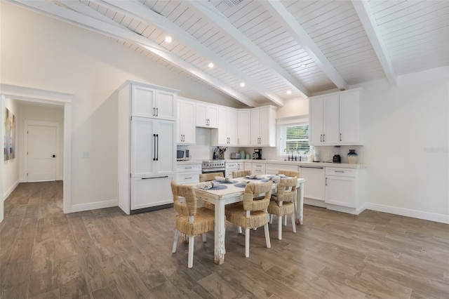 305 73rd St, Holmes Beach, FL 34217 - dining area featuring light wood-type flooring, baseboards, beam ceiling, and high vaulted ceiling