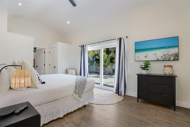 305 73rd St, Holmes Beach, FL 34217 - bedroom featuring lofted ceiling, baseboards, wood finished floors, and access to exterior