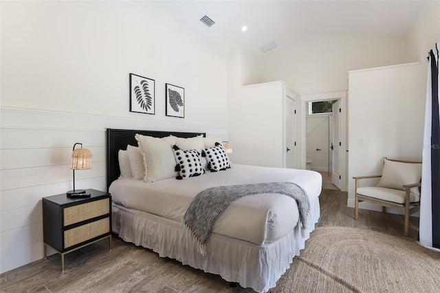 305 73rd St, Holmes Beach, FL 34217 - bedroom with lofted ceiling, wood finished floors, and visible vents