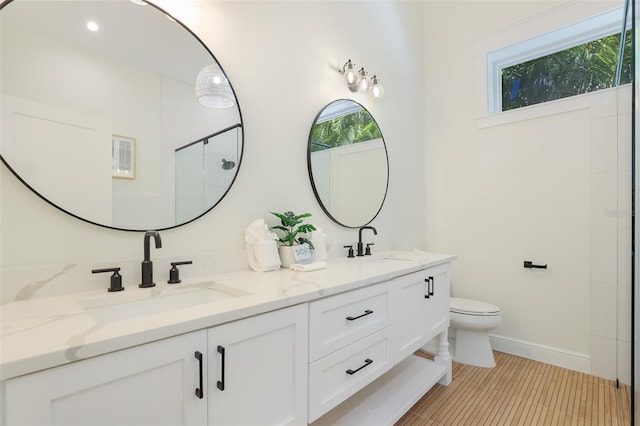 305 73rd St, Holmes Beach, FL 34217 - bathroom featuring an enclosed shower, a sink, double vanity, and toilet