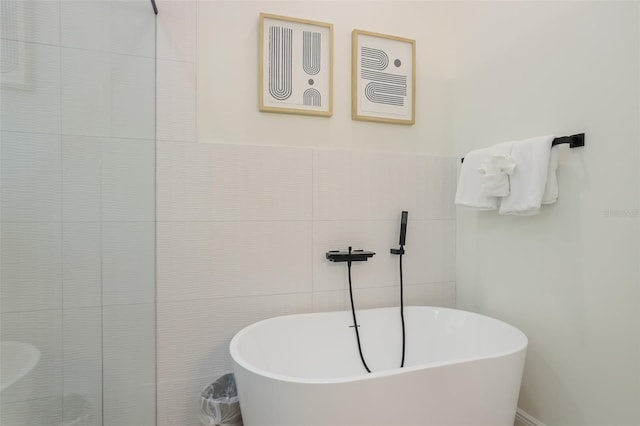 305 73rd St, Holmes Beach, FL 34217 - full bath featuring a tile shower, tile walls, and a soaking tub