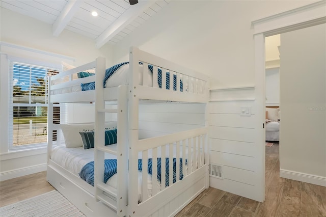 305 73rd St, Holmes Beach, FL 34217 - bedroom featuring baseboards, wood finished floors, beam ceiling, and wooden ceiling