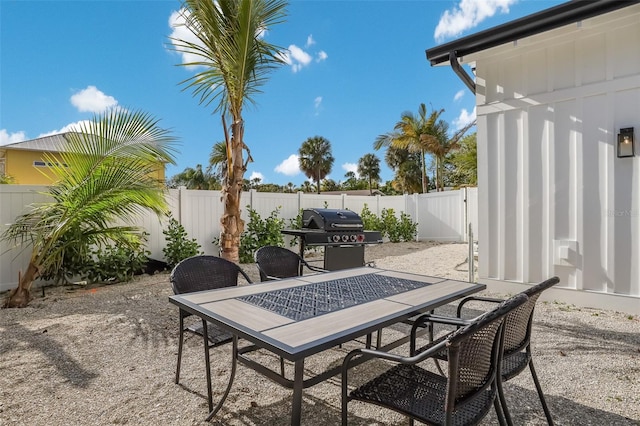 305 73rd St, Holmes Beach, FL 34217 - view of patio / terrace with area for grilling, a fenced backyard, and outdoor dining space