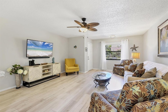 4169 66th Street Cir W Unit 4169, Bradenton, FL 34209 - living area featuring wood finished floors, a textured ceiling, ceiling fan, and baseboards