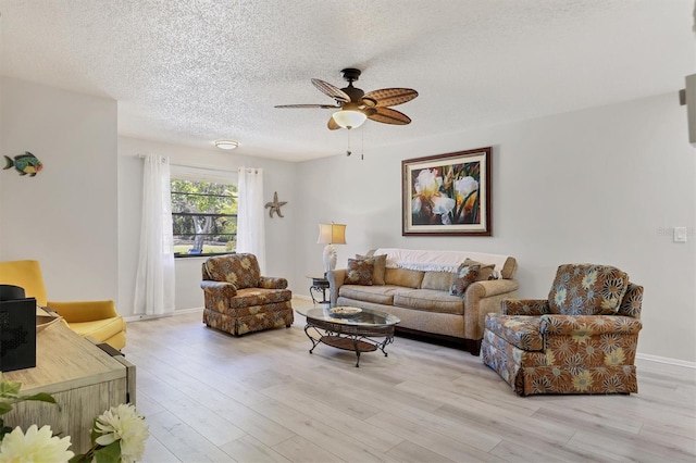 4169 66th Street Cir W Unit 4169, Bradenton, FL 34209 - living area featuring a ceiling fan, a textured ceiling, light wood finished floors, and baseboards