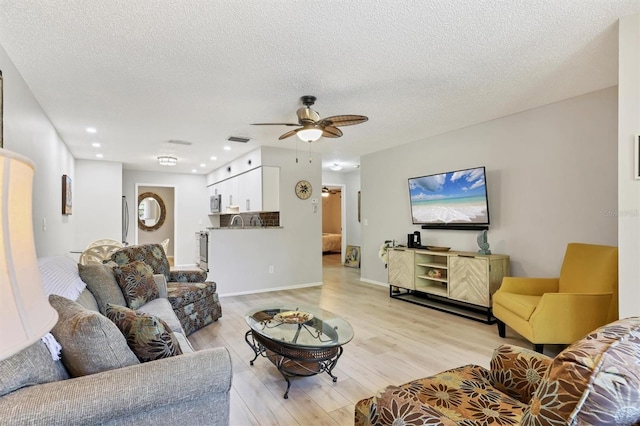 4169 66th Street Cir W Unit 4169, Bradenton, FL 34209 - living area featuring light wood-style floors, ceiling fan, a textured ceiling, recessed lighting, and baseboards