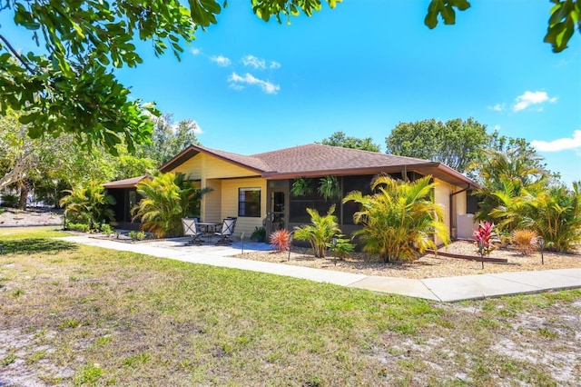 4169 66th Street Cir W Unit 4169, Bradenton, FL 34209 - view of front facade with a sunroom, a front yard, and a patio