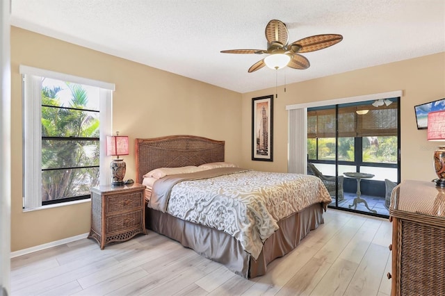 4169 66th Street Cir W Unit 4169, Bradenton, FL 34209 - bedroom with access to outside, light wood finished floors, baseboards, and a ceiling fan