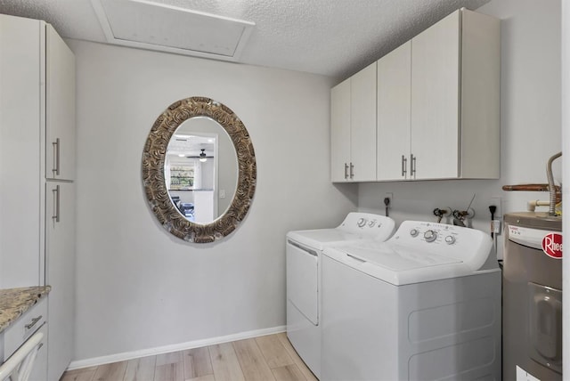 4169 66th Street Cir W Unit 4169, Bradenton, FL 34209 - laundry room with water heater, cabinet space, washer and dryer, light wood finished floors, and baseboards
