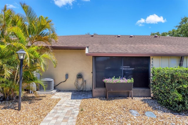 4169 66th Street Cir W Unit 4169, Bradenton, FL 34209 - view of front facade with a shingled roof, central air condition unit, and stucco siding