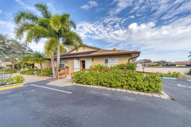 4169 66th Street Cir W Unit 4169, Bradenton, FL 34209 - view of front facade with uncovered parking, a fenced front yard, stucco siding, and a gate