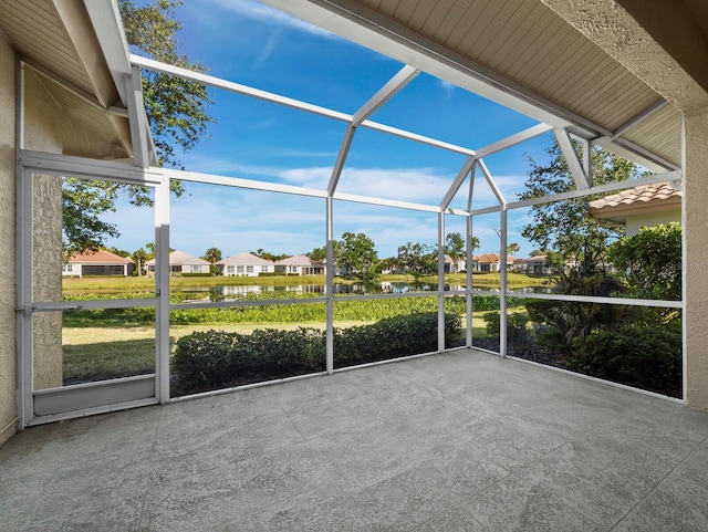 3835 Alamanda Dr, Sarasota, FL 34238 - unfurnished sunroom featuring a water view and a residential view