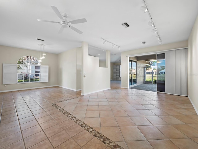 3835 Alamanda Dr, Sarasota, FL 34238 - unfurnished room featuring rail lighting, baseboards, light tile patterned flooring, and ceiling fan