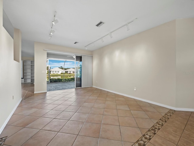 3835 Alamanda Dr, Sarasota, FL 34238 - empty room with track lighting, light tile patterned floors, and baseboards
