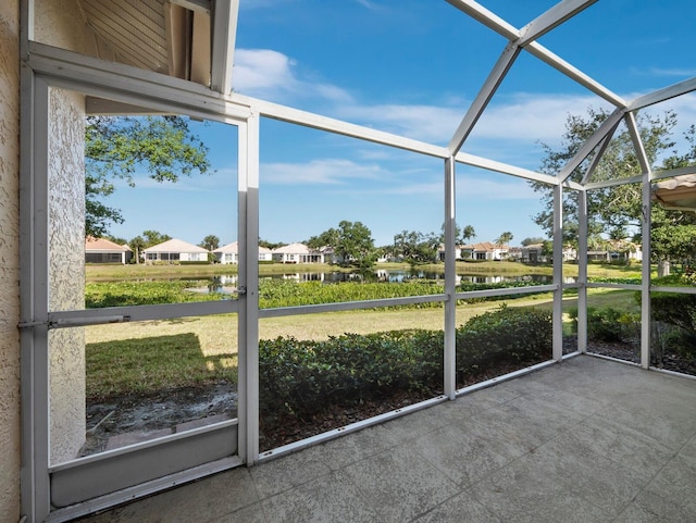 3835 Alamanda Dr, Sarasota, FL 34238 - unfurnished sunroom featuring a water view and a residential view