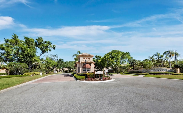 3835 Alamanda Dr, Sarasota, FL 34238 - view of asphalt street featuring curbs and a gated entry
