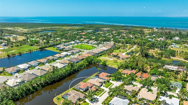 birds eye view of property with a water view and a residential view