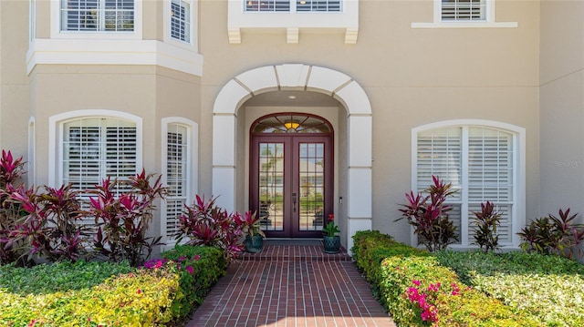 property entrance featuring french doors and stucco siding