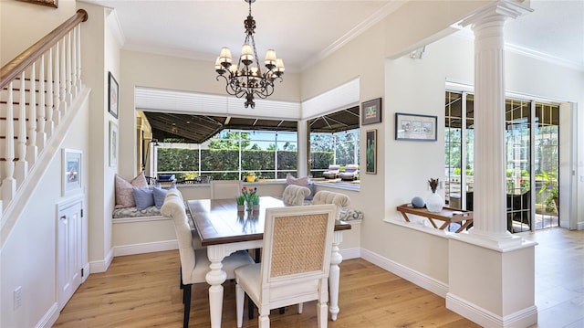 dining area with crown molding, an inviting chandelier, stairs, decorative columns, and wood finished floors