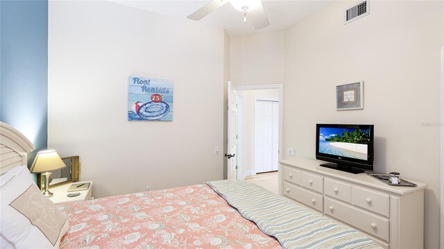 bedroom featuring visible vents, a ceiling fan, and a closet