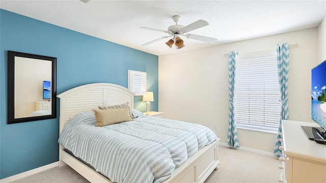 bedroom with baseboards, light carpet, and a ceiling fan