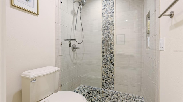 full bath featuring a stall shower and toilet