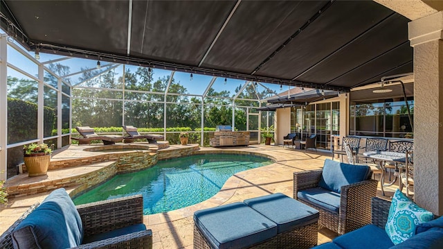 view of swimming pool with a patio, a pool with connected hot tub, and a lanai