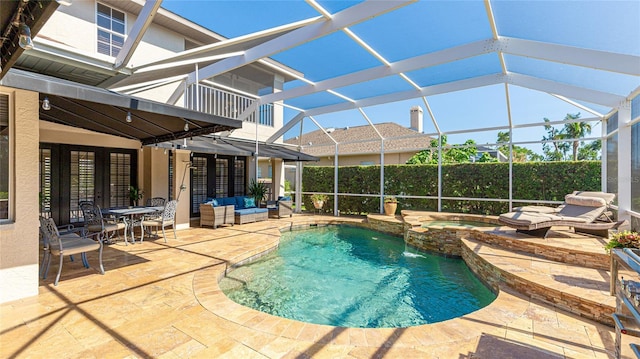 view of pool with a fenced in pool, an in ground hot tub, an outdoor living space, a patio area, and a lanai