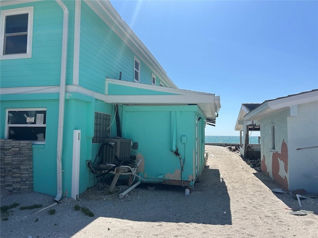 view of side of home with a water view